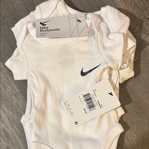 Nike White Infant Bodysuit with Black Logo